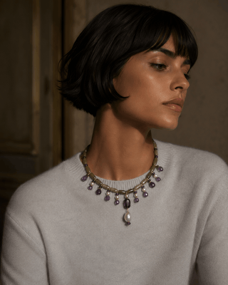 Model wearing a serpentine, amethyst and blue-grey freshwater pearl statement collar necklace
