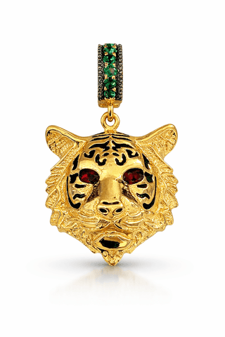 Gold tiger pendant with red and green gemstones on a white background