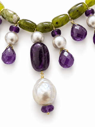 Close-up of serpentine gemstones, amethyst and blue-grey freshwater pearls set in vermeil