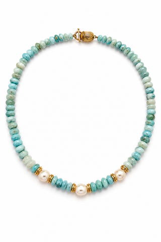 A beaded necklace featuring light blue and green marbled stone beads, white faux pearls, and gold spacer rings, displayed on a clean white background.