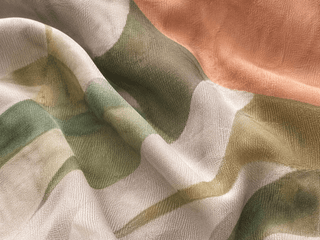 Close-up of fabric with green, white, and peach colors.